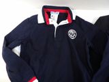 polo shirt and pants laying on a bed in a room