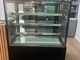 a glass display case in the middle of a room