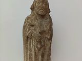 statue d'une femme tenant un enfant dans ses bras, posée sur une étagère en verre