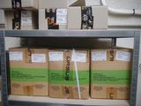 many boxes on a metal shelf in a room