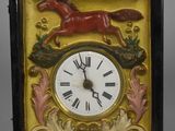a picture of a clock with a horse on it