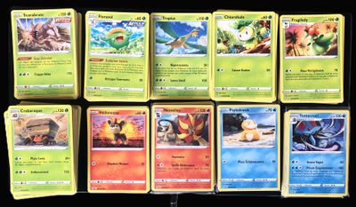 several pokemon cards sitting on top of each other on a table