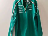 Le t-shirt est vert et blanc, avec une rayure noire et blanche.