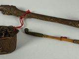 two wooden sticks and a wooden bucket on a table