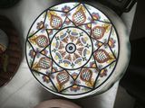 a plate with a design on it sitting on a table