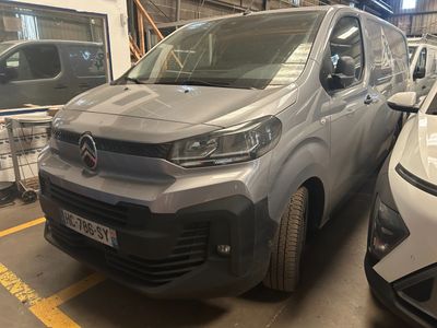 La camionnette est garée dans le garage, à côté d'autres voitures.