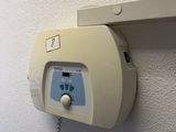 a white wall mounted device attached to a wall