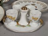 a table with a plate, cups and saucers on it