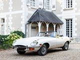 a white car parked in front of a large house