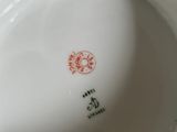 a white plate with a red design on it