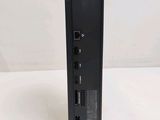 a close up of a small black device on a white surface