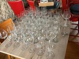 many wine glasses sitting on a table in a room