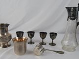 a lot of silver and glass items on the table