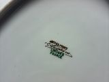 a close up of a white plate with a green label on it