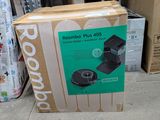 a cardboard box that is sitting on the ground next to a pile of boxes