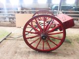 a red wagon that is sitting in a barn