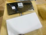 a laptop sitting on top of a table next to a sheet of paper