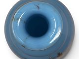 a blue vase with a hole in the middle of it