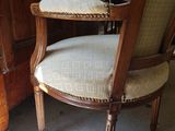 a chair that is sitting in front of a cabinet