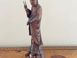 a statue of a woman holding a peace sign