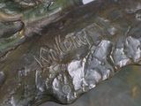 a close up of a bronze statue of a bird