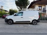 a white van parked in a parking lot next to a building