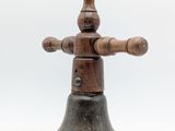 an old wooden bell with a wooden handle on a white background