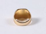a close up of a gold ring on a white surface