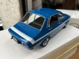 a blue toy car sitting on top of a white box