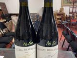 two bottles of wine sitting on a table in a room