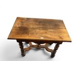 an old wooden table with a small drawer on top of it