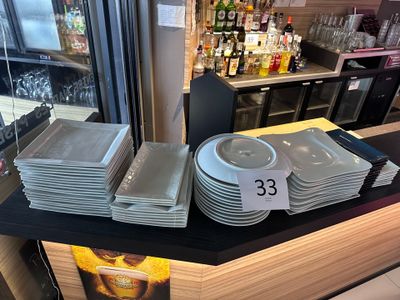 many plates and pans on the counter in the store