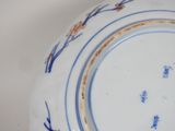 a blue and white plate with writing on it