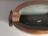 a metal bowl with a glass inside of it