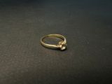 a close up of a gold ring on a black surface