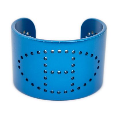 a close up of a blue bracelet with holes on it