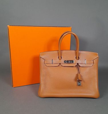 an orange box and a brown bag sitting next to each other
