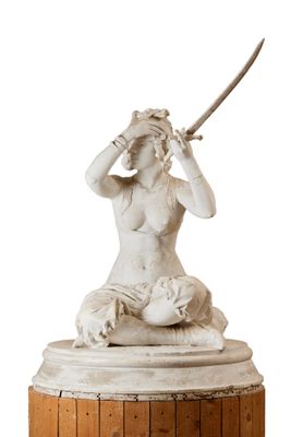 statue of a woman with a sword on a wooden pedestal