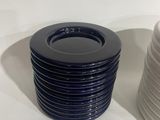 a lot of plates stacked on top of each other on a table