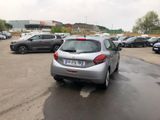 a silver car parked in a parking lot next to other cars