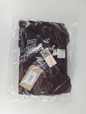 a close up of a bag of brown clothing on a white surface