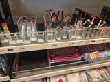 a lot of makeup products on the shelves in the store