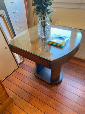 a glass table with a vase of flowers on top of it