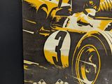 a poster of a racing car on the wall
