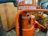 an orange machine that is sitting in a room
