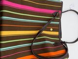 a close up of a purse hanging on a wall