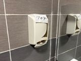 deux distributeurs de savon fixés au mur de la salle de bains