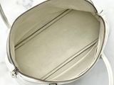 the inside of a white purse on a marble surface