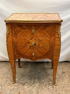 a wooden chest of drawers sitting on top of a floor