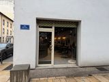 a white building with a blue sign on the front of it